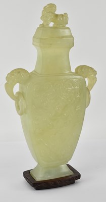 Lot 565 - A Chinese carved green jade twin handled...