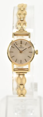 Lot 913 - OMEGA; a 9ct yellow gold lady's wristwatch on...