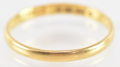 Lot 753 - A 22ct yellow gold wedding band, size N,...