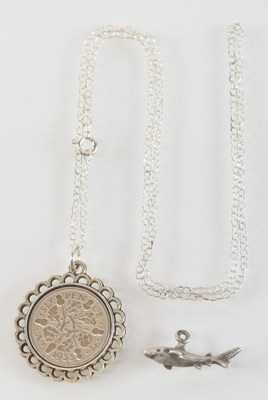 Lot 889 - A 1933 sixpence set in white metal mount,...
