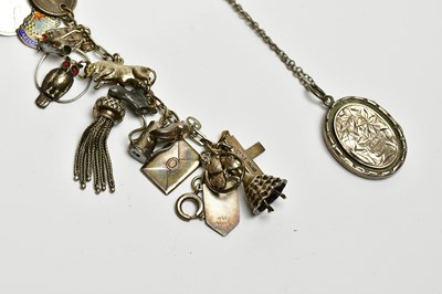 Lot 474 - A silver charm bracelet and a silver locket on...
