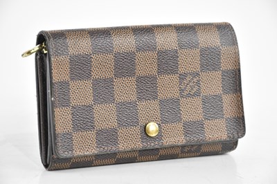 Lot 1911 - LOUIS VUITTON; a brown Damier leather purse,...