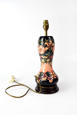 Lot 288 - MOORCROFT; a waisted baluster lamp in tube...