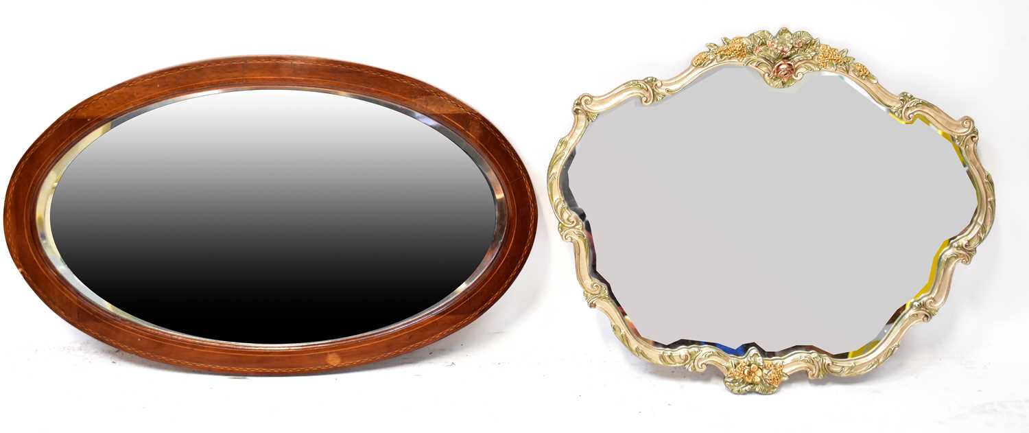 Lot 111 - An Edwardian inlaid mahogany oval wall mirror...