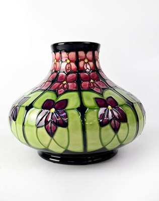 Lot 289 - MOORCROFT; a squat baluster vase in tube lined...