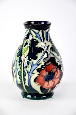 Lot 293 - MOORCROFT; a baluster vase with green ground...