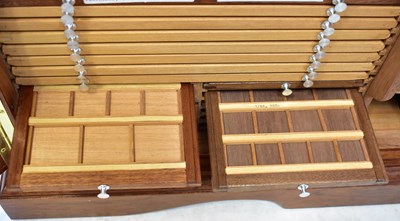 Lot 100 - A wooden two-door coin cabinet with dividing...
