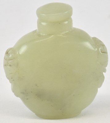 Lot 595 - A Chinese green jade snuff bottle, flanked by...