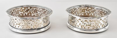 Lot 608 - A pair of 19th century white metal wine bottle...