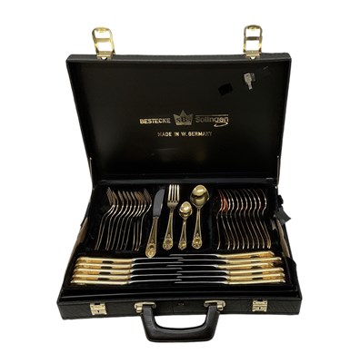 Lot 605 - BESTECKE SOLINGEN; a German cased gold plated...