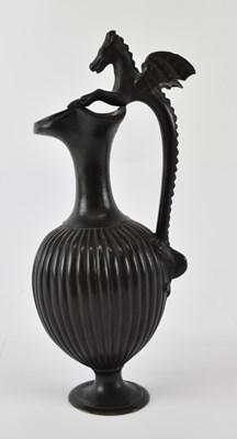 Lot 534 - A bronze ewer, with handle modelled as leaping...