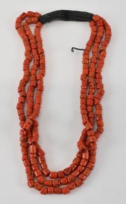 Lot 809 - A three strand coral bead necklace, length...
