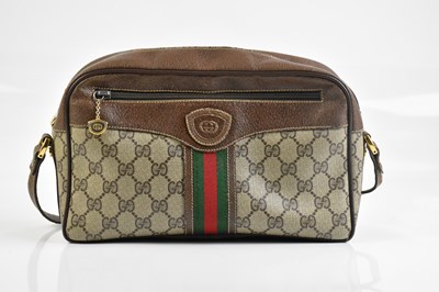 Lot 2034 - GUCCI; a vintage coated canvas and leather...