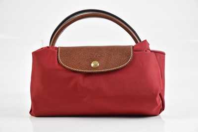 Lot 2058 - LONGCHAMPS; a large red canvas Le Pliage bag,...
