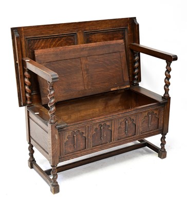 Lot 70 - A 1930s oak monk's bench with lift-up seat, on...
