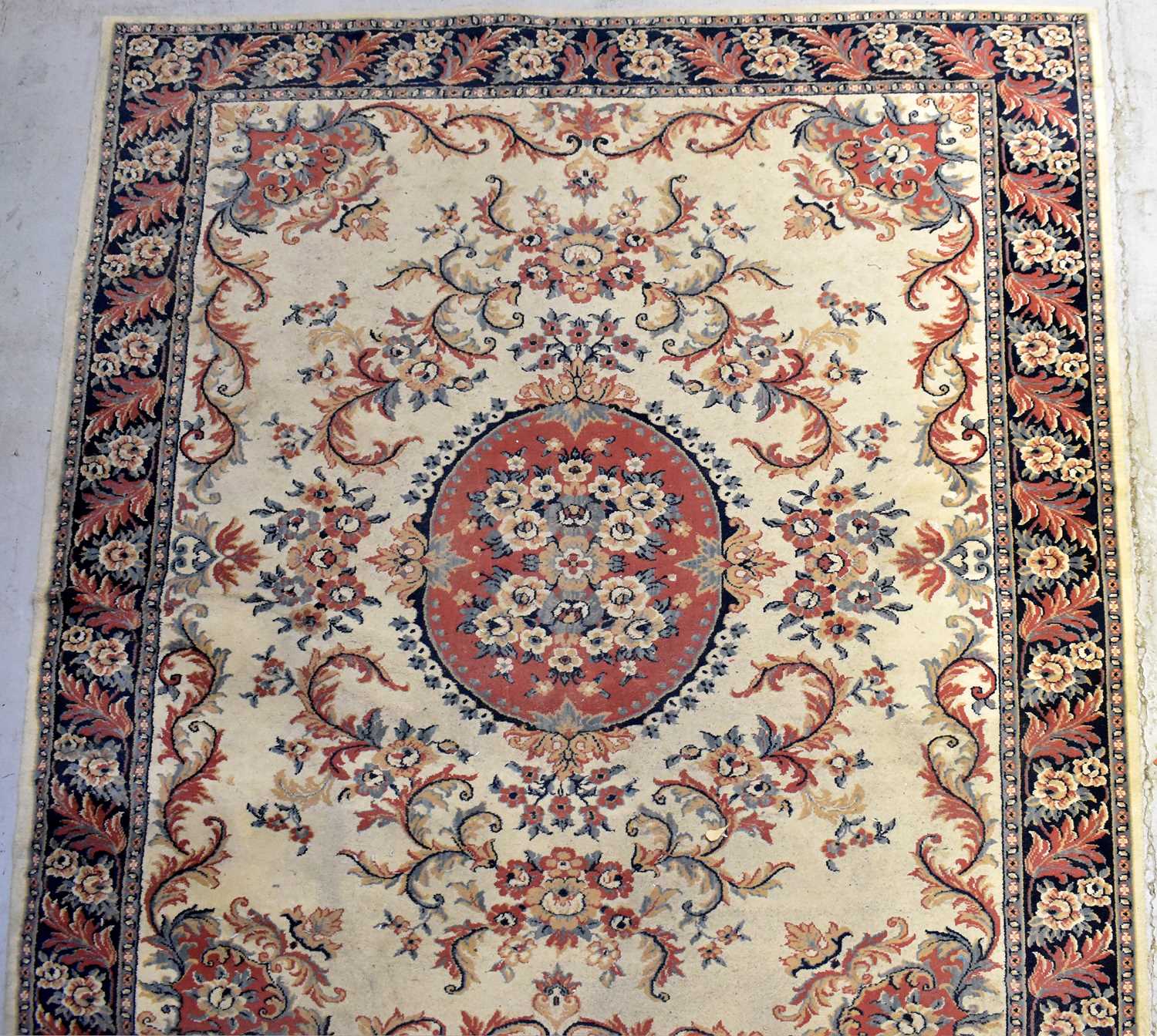 Lot 119 - A wool carpet of cream ground with...