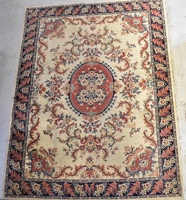 Lot 119 - A wool carpet of cream ground with...