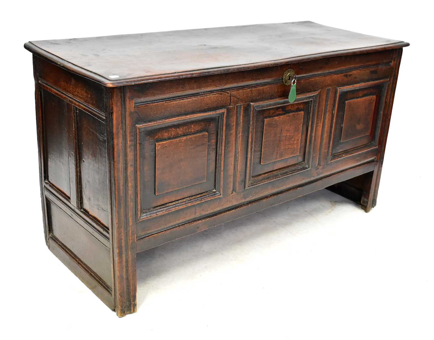 Lot 101 - A Georgian oak coffer, the base with fielded...