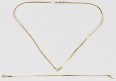 Lot 870 - A 9ct gold flat link necklace terminating in a...