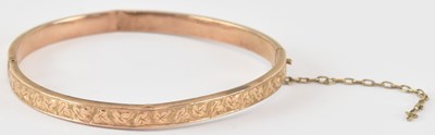 Lot 795 - A 9ct rose gold hollow hinged bracelet, one...