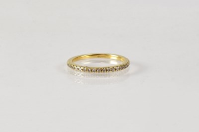 Lot 833 - An 18ct yellow gold half eternity ring set...