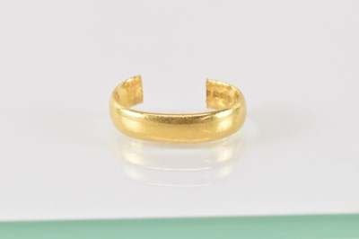 Lot 748 - A 22ct gold band ring (cut and opened up),...