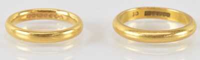 Lot 749 - A pair of 22ct gold thin band rings, sizes J...