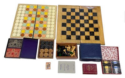 Lot 323 - A folding chessboard, with cased chess set and...