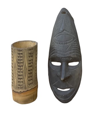 Lot 1127 - A Melanesian carved wooden oval wall hanging...