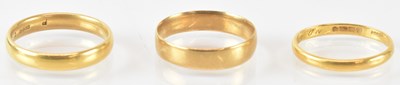 Lot 728 - A 22ct wedding band, size Q, a further 22ct...