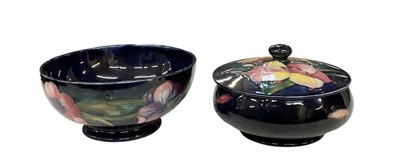 Lot 472 - MOORCROFT; a blue ground floral decorated bowl,...
