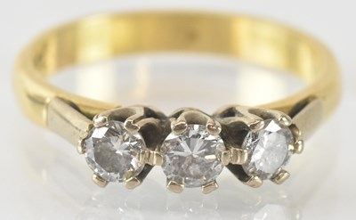 Lot 735 - An 18ct yellow gold three stone diamond ring,...