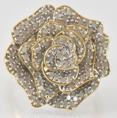 Lot 764 - A 9ct yellow gold diamond set flower head ring,...