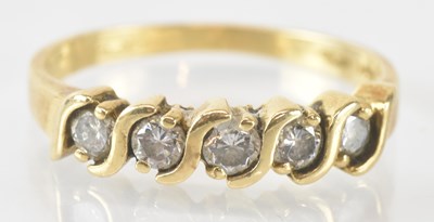 Lot 786 - A 14ct yellow gold five stone diamond set ring,...