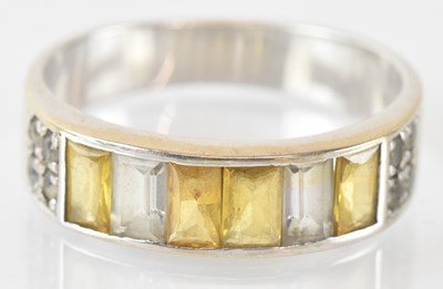 Lot 763 - An 18ct white gold yellow sapphire and diamond...