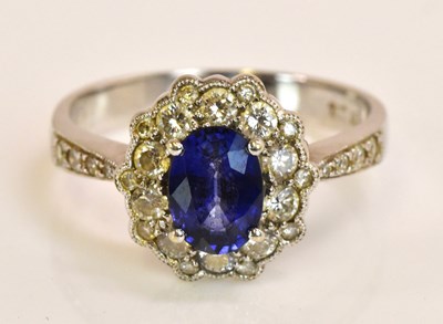 Lot 510 - An 18ct white gold sapphire and diamond oval...