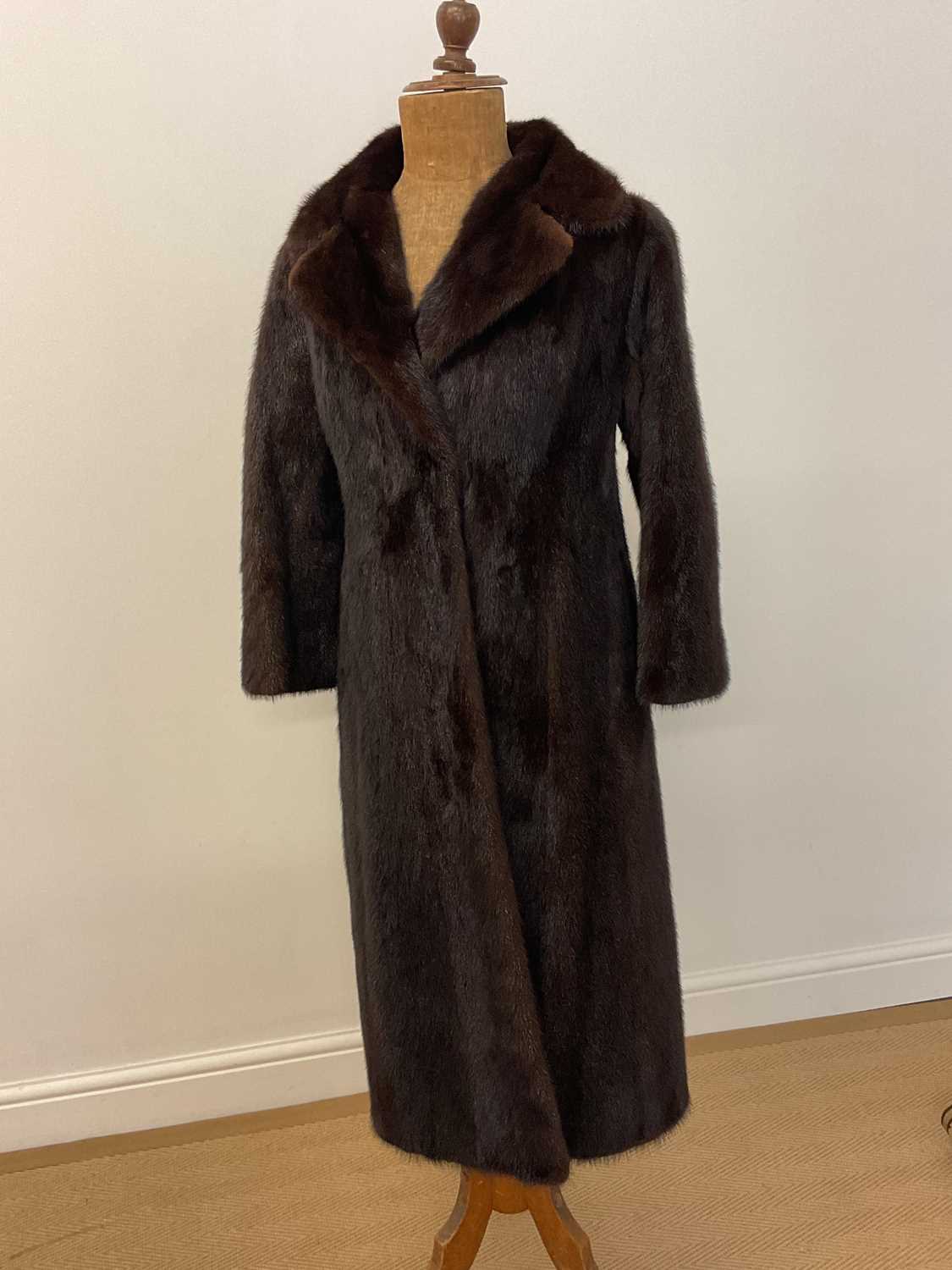 Lot 85 - A full length dark brown mink coat with 3/4...