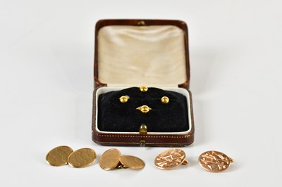 Lot 1703 - A pair of 9ct yellow gold cufflinks and a set...