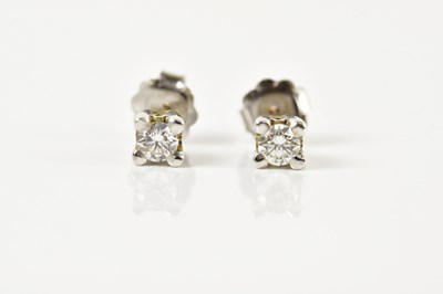 Lot 1675 - A pair of white metal diamond ear studs, each...
