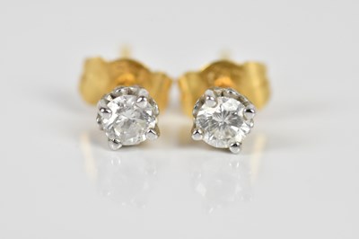Lot 1679 - A pair of yellow metal diamond ear studs, each...
