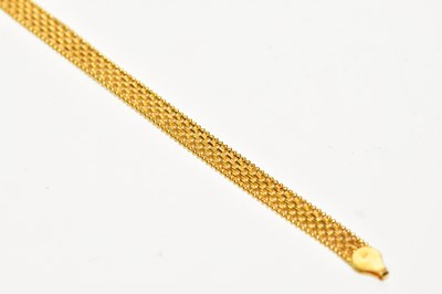 Lot 213 - A yellow metal mesh link bracelet, stamped...