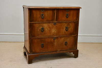 Lot 171 - A Georgian walnut chest of two short over two...