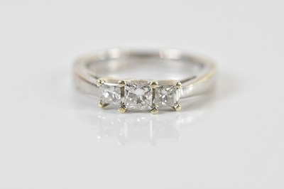 Lot 1340 - A 9ct white gold three stone graduated diamond...