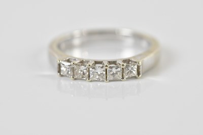 Lot 1341 - A 9ct white gold five stone princess cut...